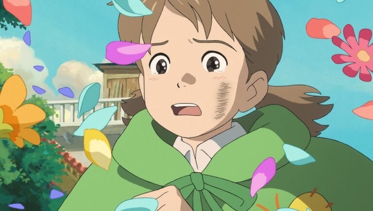 A tearful girl with a smudge on her cheek wears a green cloak as colorful flower petals drift around her.