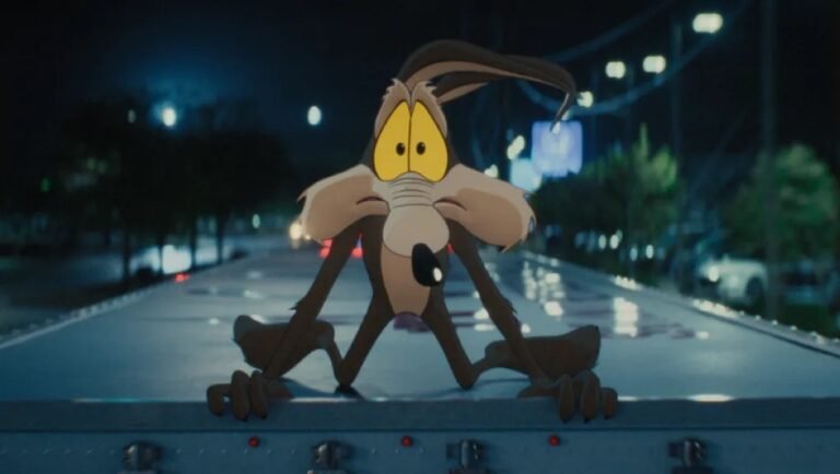 Wile E. Coyote looks distressed while clinging to the top of a moving truck at night.