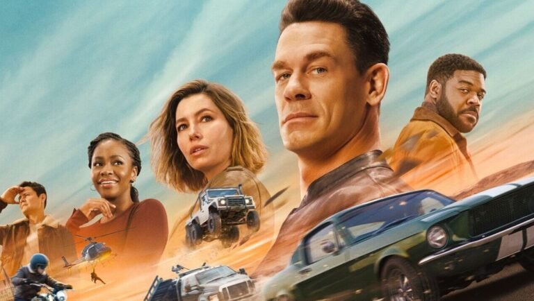 Mark Wahlberg and an ensemble cast pose amid action vehicles on a desert backdrop in the Uncharted movie poster.